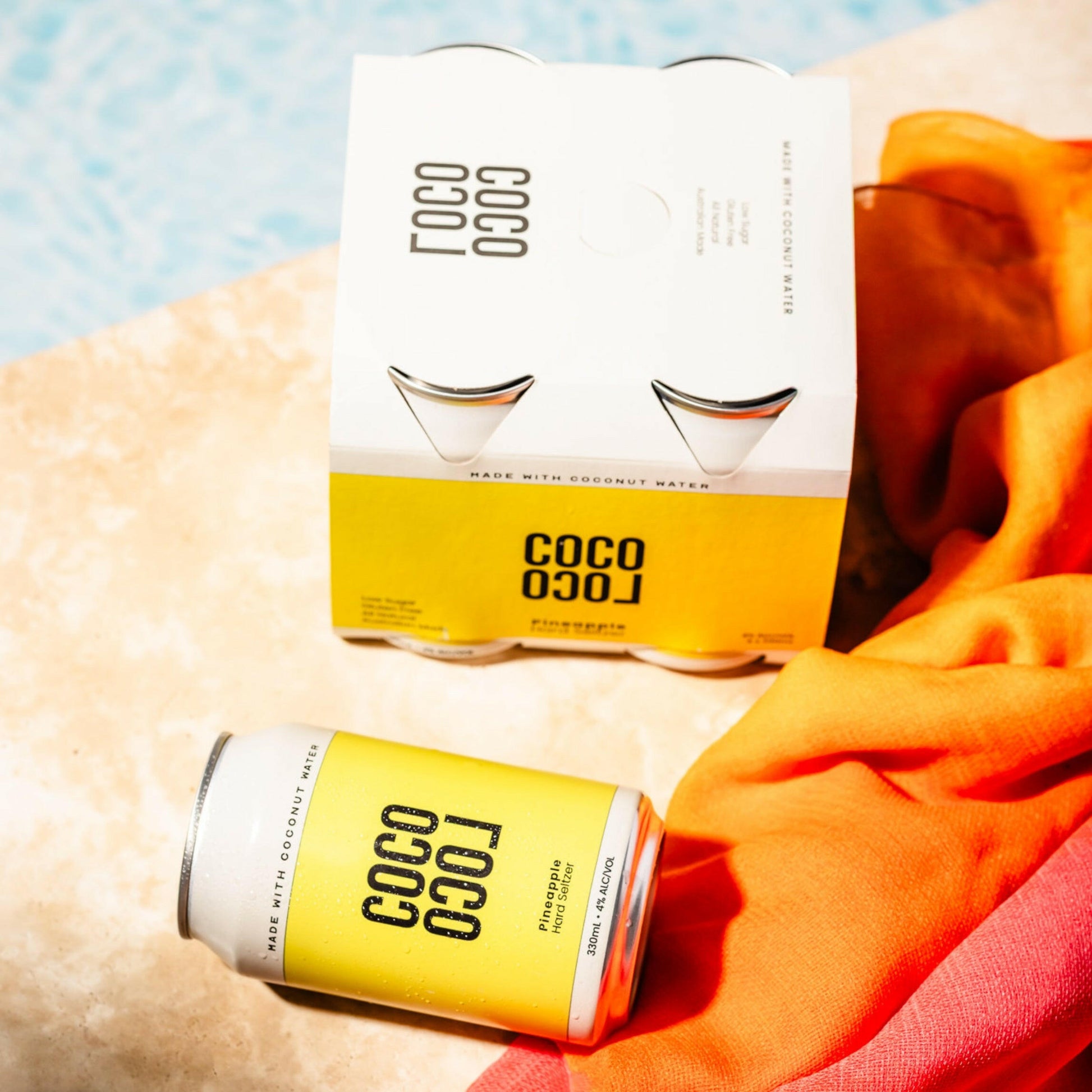 COCO LOCO drink pina colada 4-pack on a tiled pool surface with a colourful background