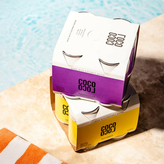 Coco Loco drinks mixed-pack packaging on a towel with a pool in the background