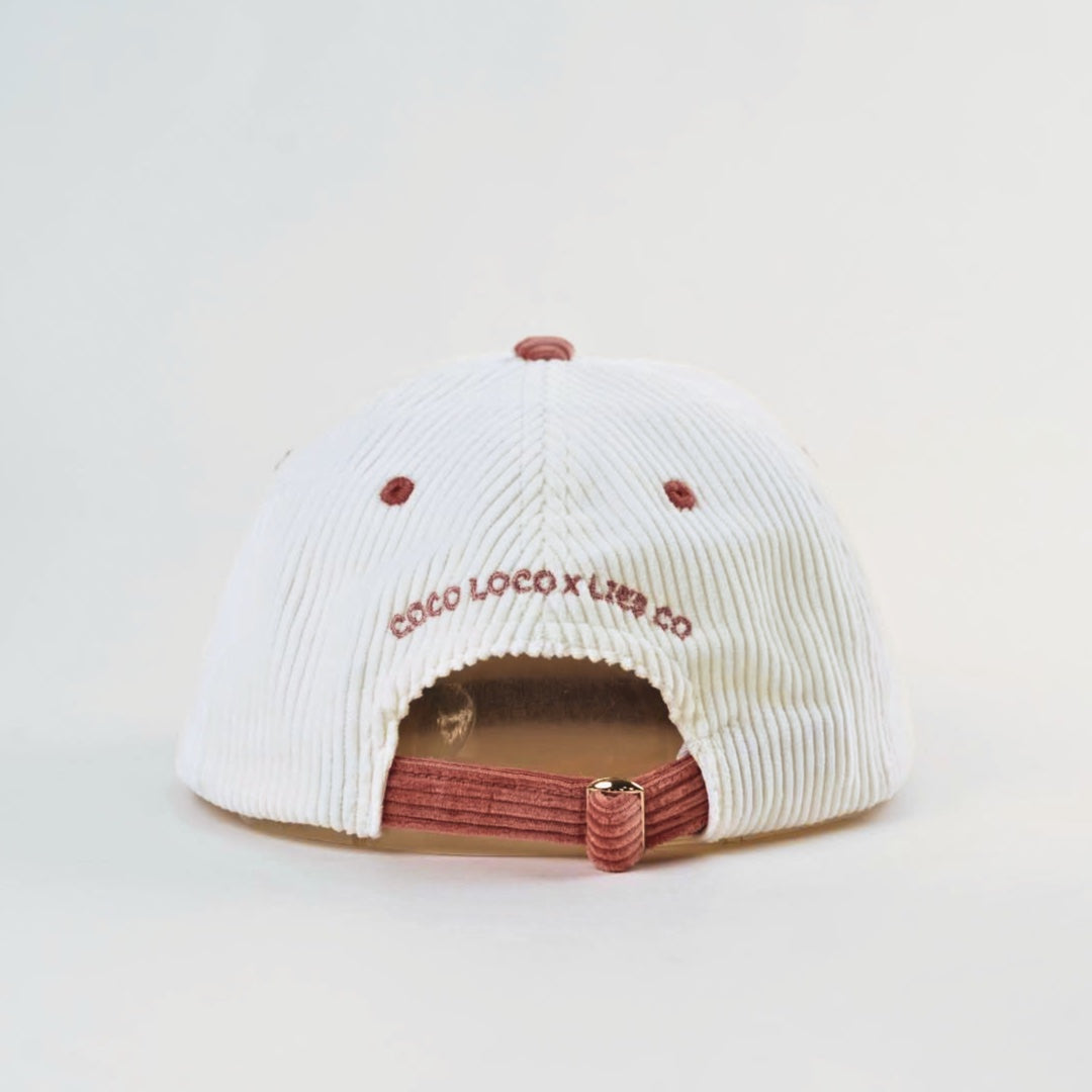 Coco Loco x Lies Collective Pina Colada cap, white corduroy with dusty pink brim and adjustable clip, back view