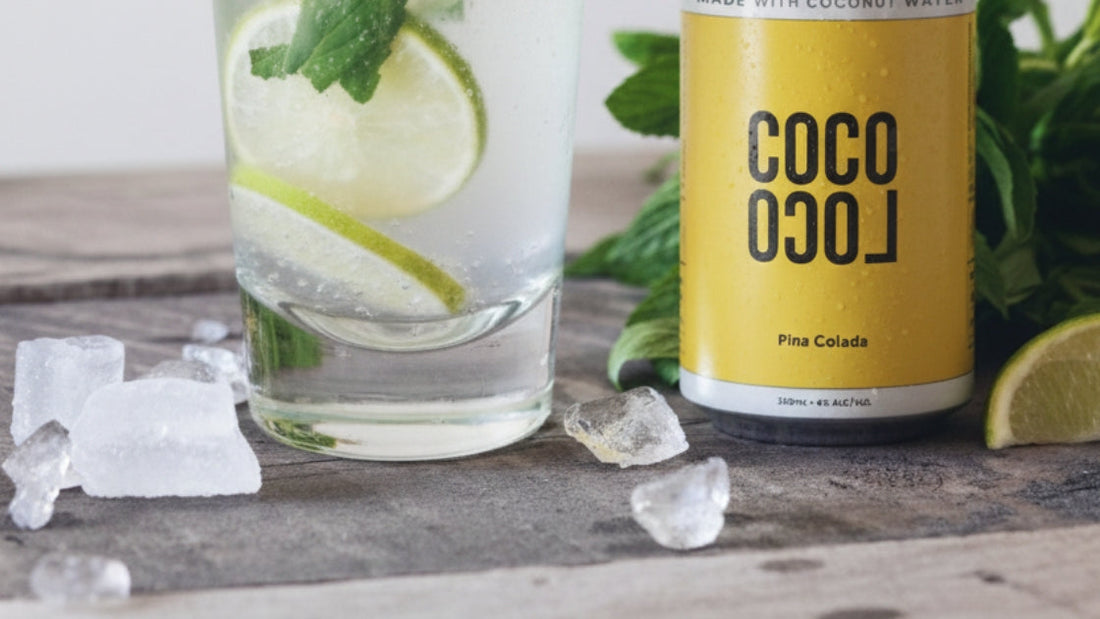 Coco Loco Pineapple Coconut Hard Seltzer with tall glass and fresh lime