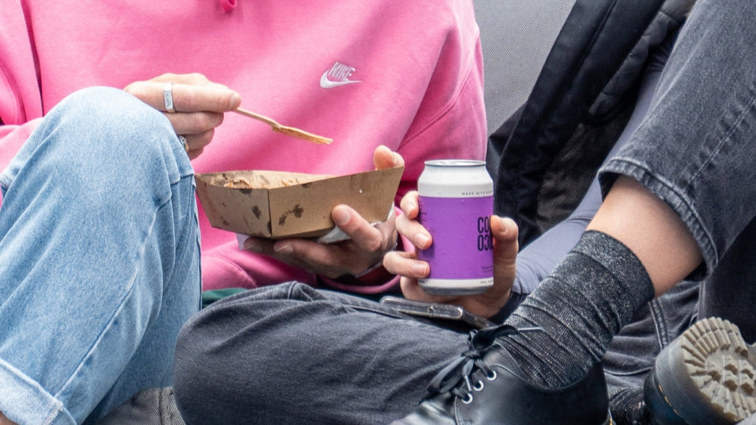 Passionfruit coconut water purple can and person in pink Nike sweater
