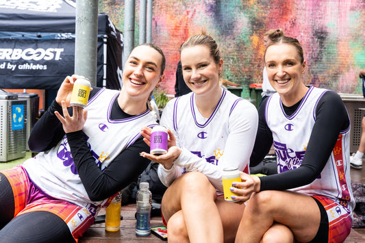 Athletes holding yelloe and purple cans of Coco Loco all natural hard seltzer