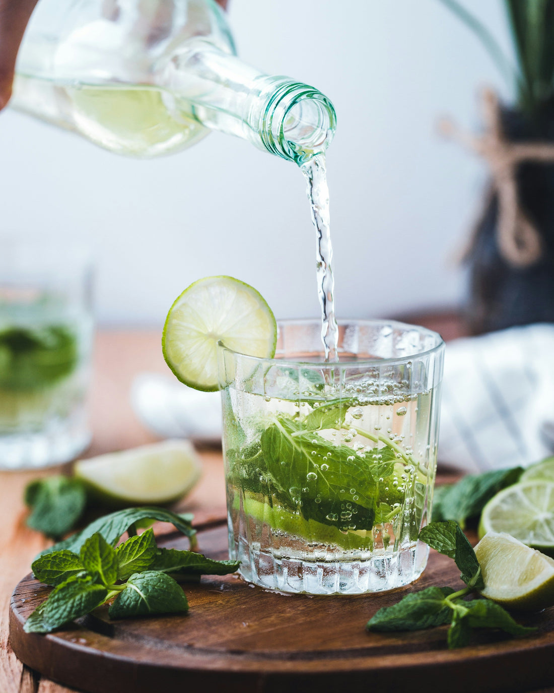 Hugo Spritz in short glass with fresh mint, elderflower cordial, fresh lime image by mae-mu-unsplash