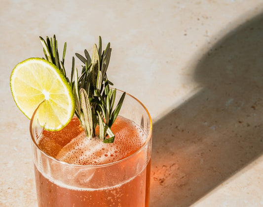 Coconut Gin Fizz in a clear glass with fresh botanicals. Photo by No Revisions on Unsplash