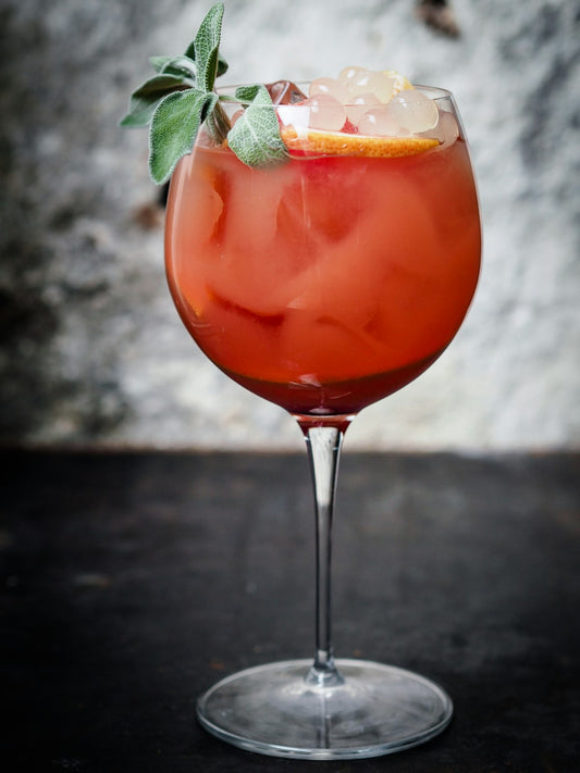 Coco Loco Affogato cocktail in a wine glass with botanical garnish. Photo by Daniel Horvath on Unsplash