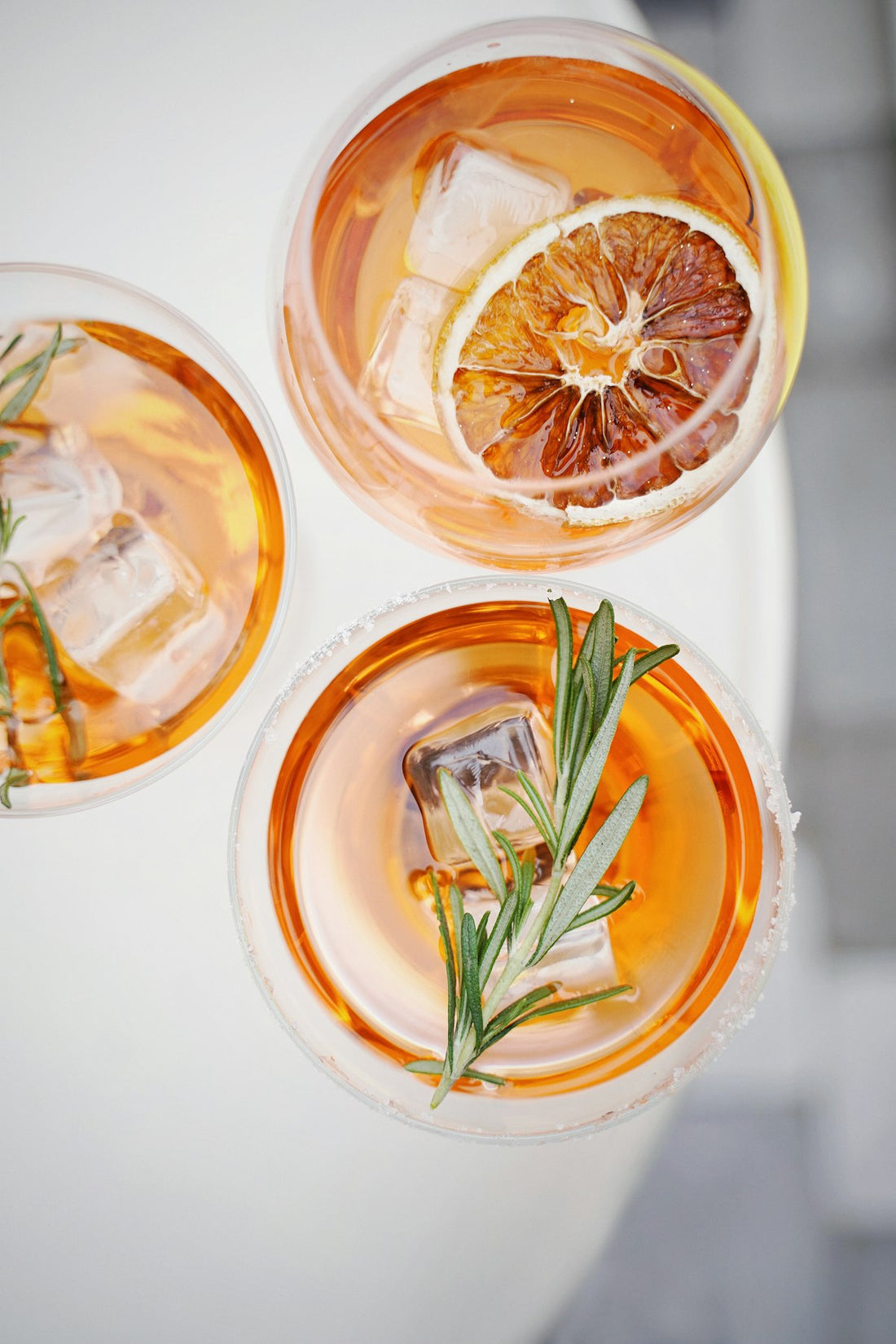 Pineapple Spritz cocktails with fresh citrus and herb garnish. Photo by Olena Bohovyk on Unsplash