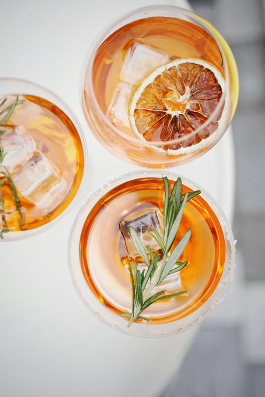 Pineapple Spritz cocktails with fresh citrus and herb garnish. Photo by Olena Bohovyk on Unsplash