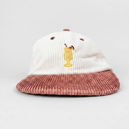 Piña Colada corduroy hat, front view, white 6 panel crown with embroidered cocktail glass and dusty pink brim
