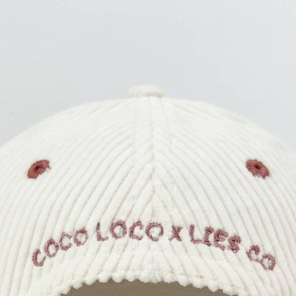 Back of the Pina Colada cap with COCO LOCO x LIES CO embroidered across white corduroy