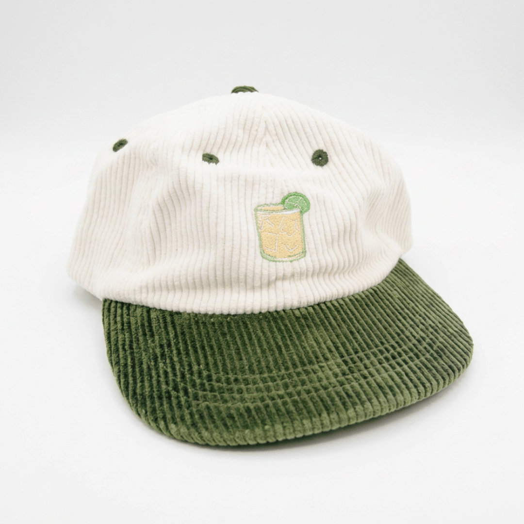 Coco Loco × Lies Collective Margarita cap — embroidered Margarita cocktail on white corduroy, olive brim, three-quarter front view