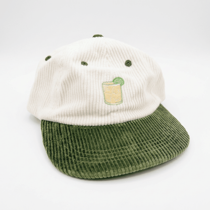 Coco Loco × Lies Collective Margarita cap — embroidered Margarita cocktail on white corduroy, olive brim, three-quarter front view