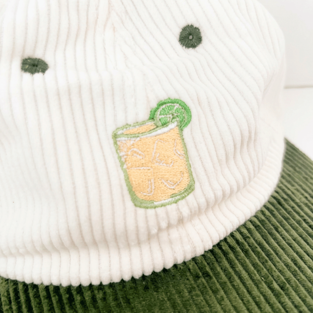 Coco Loco × Lies Collective Margarita cap — close-up of embroidered Margarita cocktail with lime garnish, corduroy texture detail