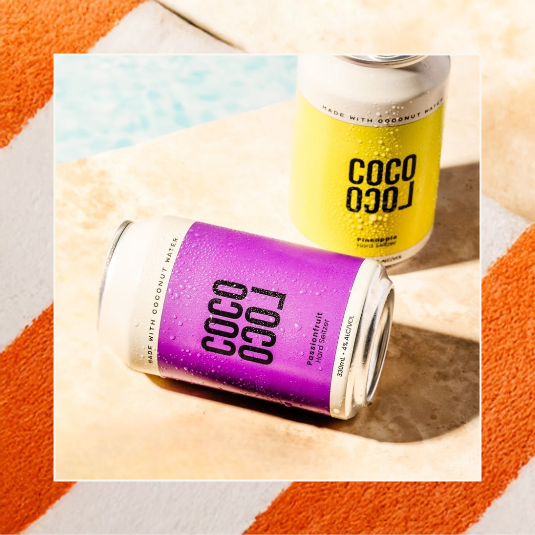Can of Brewed Coconut Water Passionfruit flavour lying down poolside with Pineapple in background