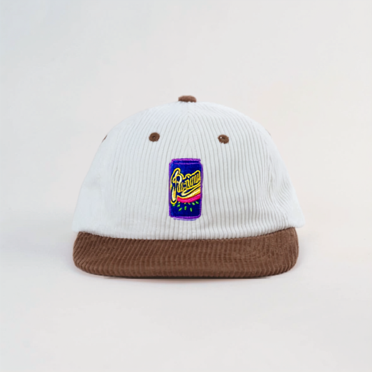 Coco Loco × Lies Collective Iconic Passiona cap — white corduroy dad cap with brown brim and embroidered Passiona can, front view