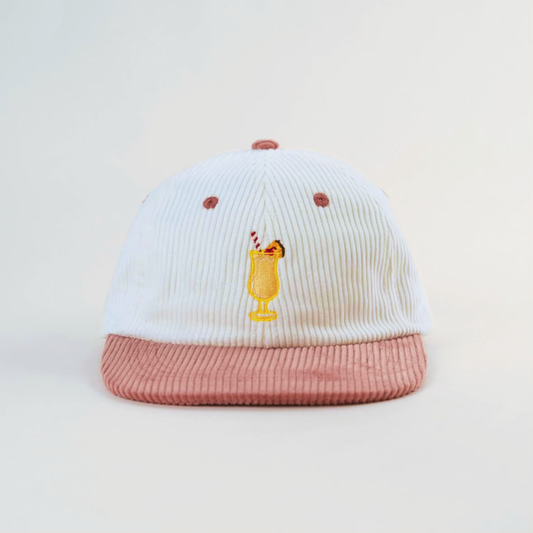 Coco Loco × Lies Collective Piña Colada cap — white corduroy dad cap with pink brim, front view