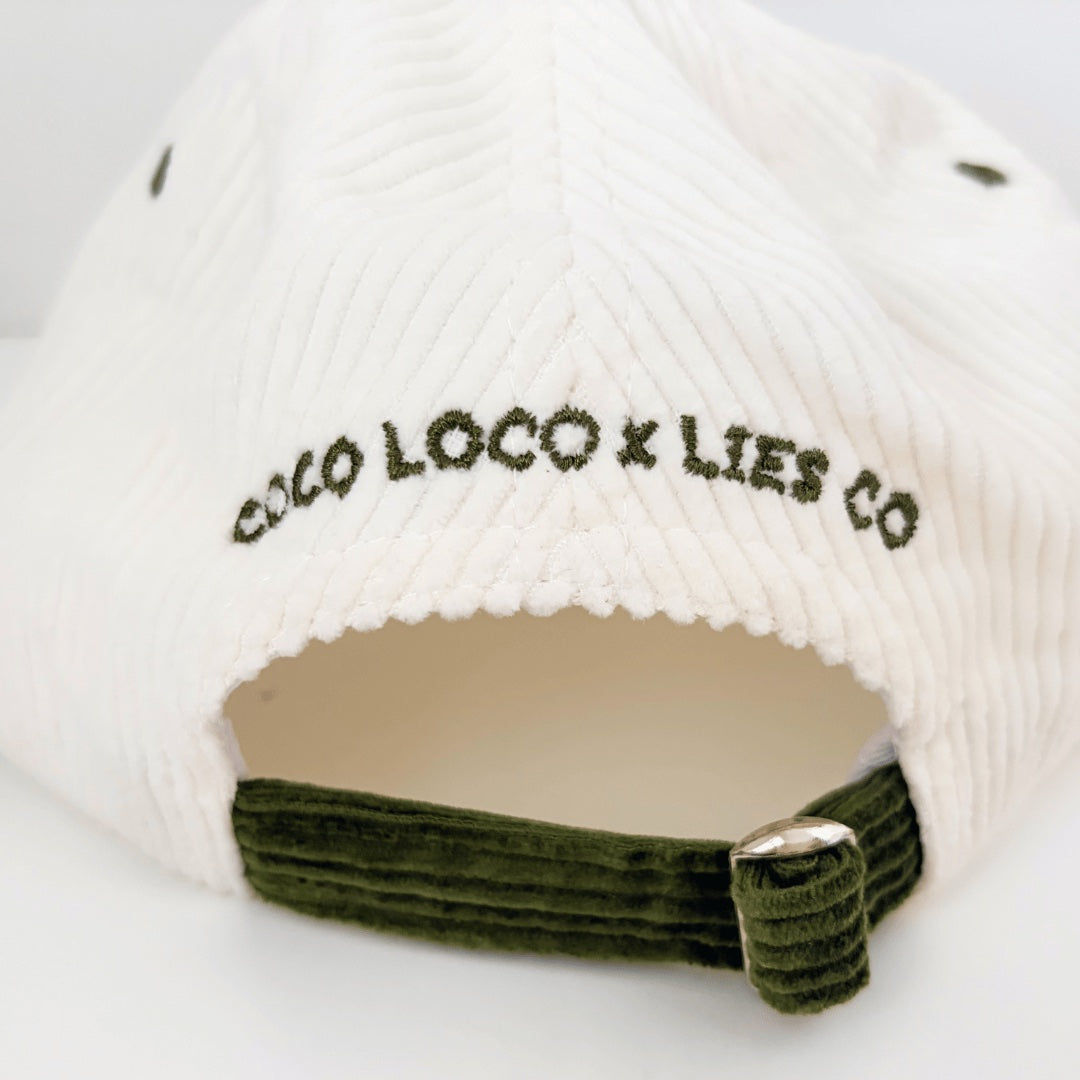 Back of the Margarita cap with COCO LOCO x LIES CO embroidered in olive above the adjustable metal clip